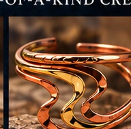 Flowing two-tone copper and gold sculptural cuff